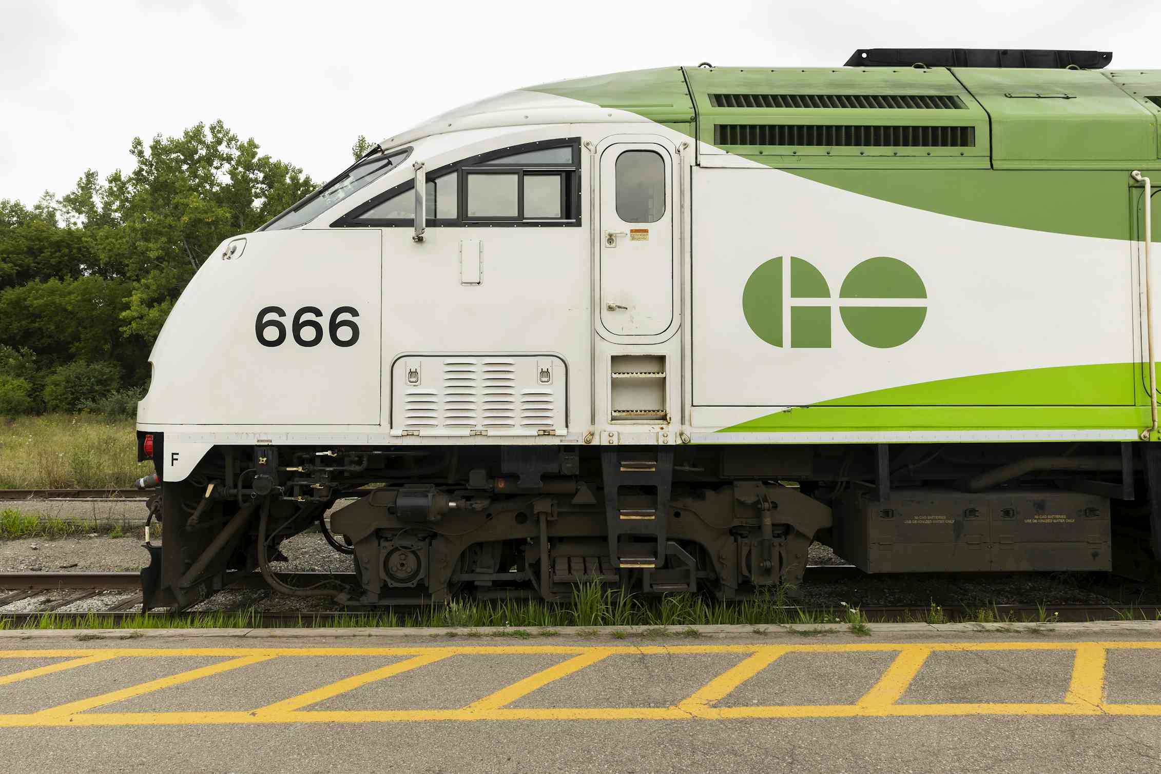 A GO Transit train sits parked at a station