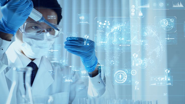 a scientist in a lab coat, mask and goggles drops liquid into a test tube and digital graphics float in the air nearby