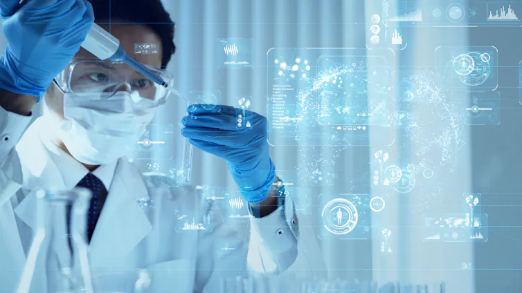 a scientist in a lab coat, mask and goggles drops liquid into a test tube and digital graphics float in the air nearby