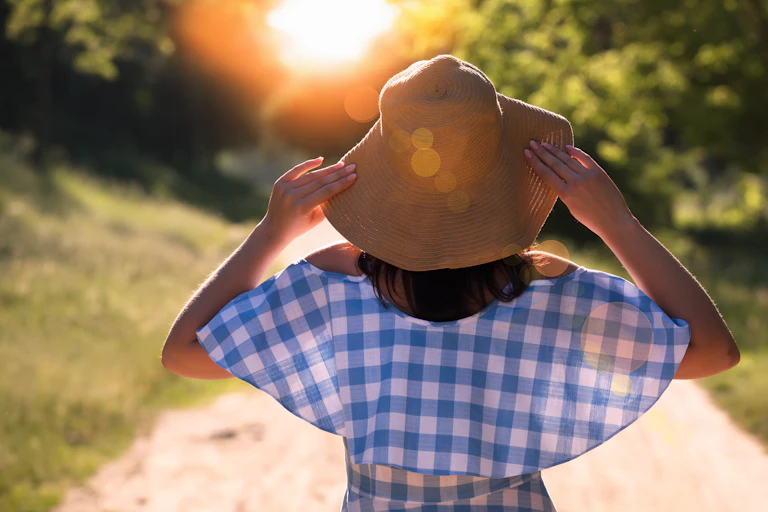 Back view of woman in a straw hat