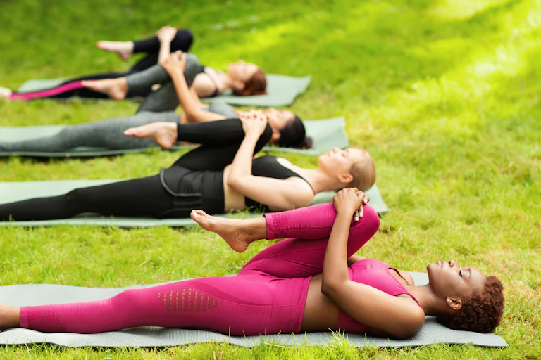 A group of women stretching their leg during yoga class