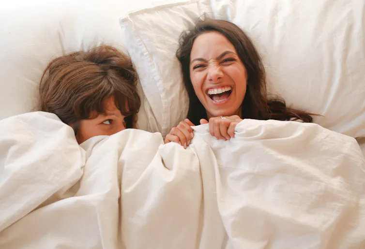 Two women in bed together.