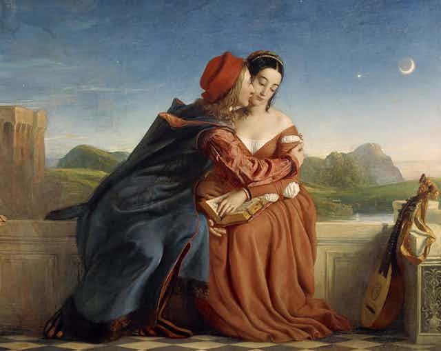 Paolo leans in to kiss the cheek of Francesca. He wears a red hat and she a red dress. The moon is rising in the sky behind them.