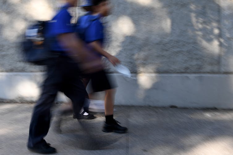 Two students walking to school.