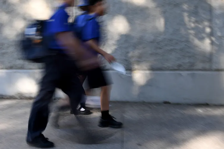 Two students walking to school.
