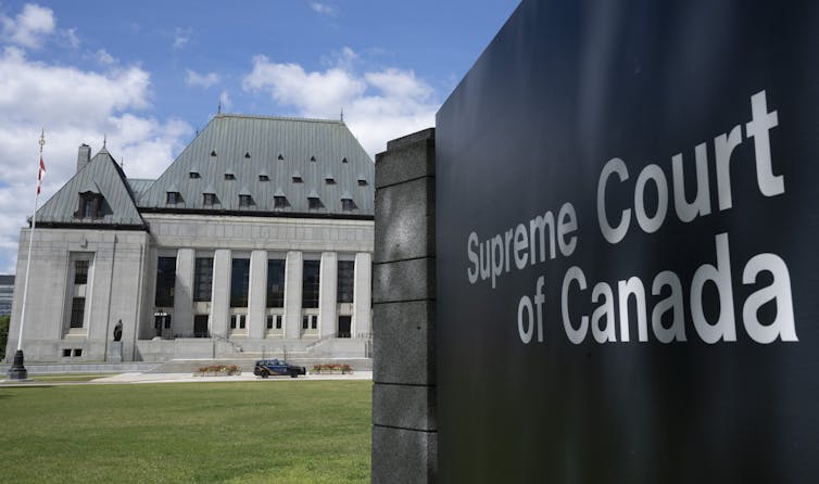 A sign in the foreground reading Supreme Court of Canada with a building in the background