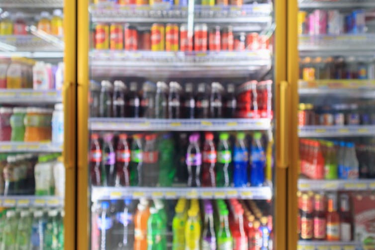 A fridge containing soft drinks.