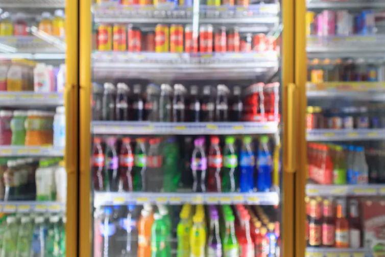 A fridge containing soft drinks.