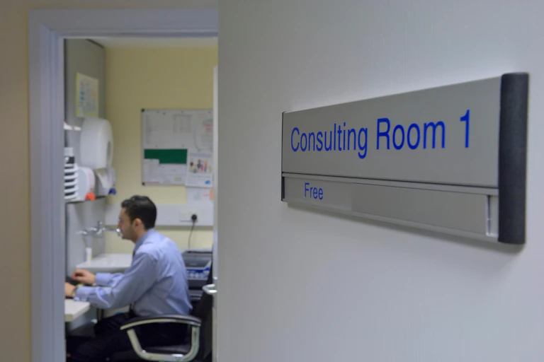 A GP in his consulting room