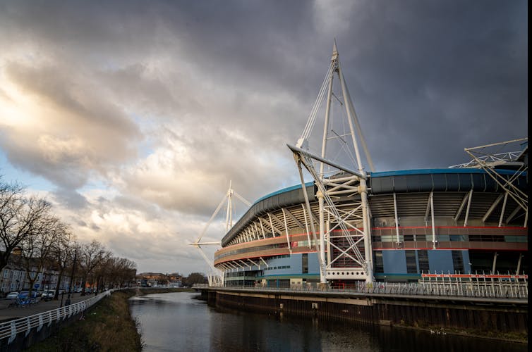 A cloudy sky above the Principality Stadium. The river Taf runs alongside it.