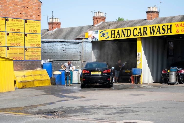 Hand car wash in progress.