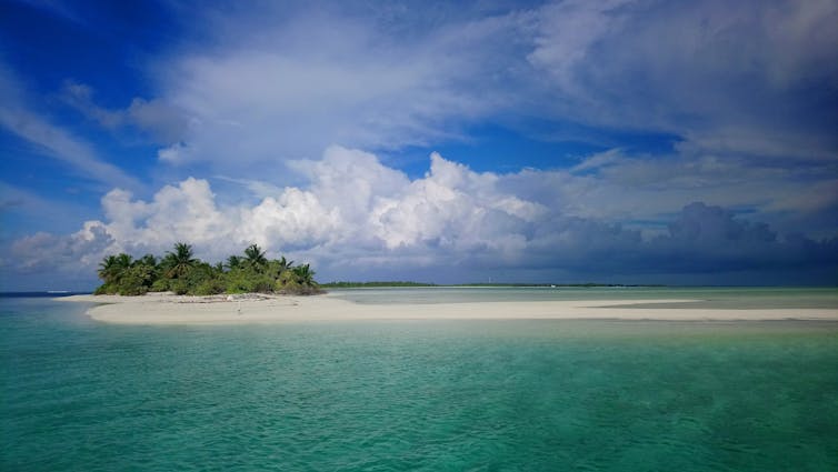 A tropical coral reef island of white sand.
