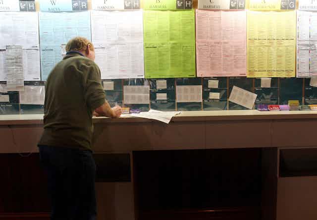 A man fills out a betting slip.