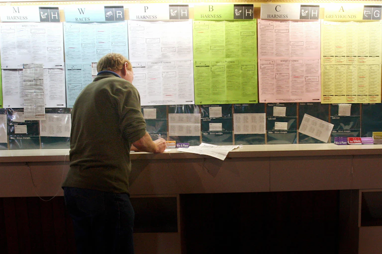 A man fills out a betting slip.