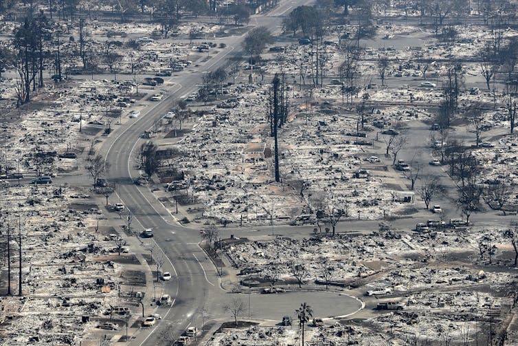 Streets with burned cars and nothing left of homes but ash.