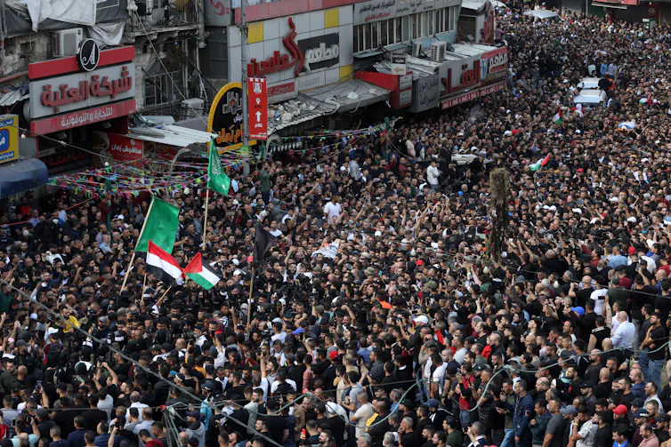 Mourners carry the bodies of five Palestinians killed by Israeli troops.