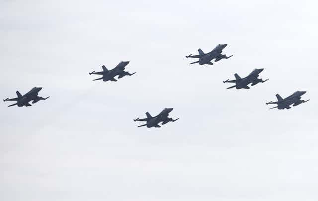 Six F-16 fighters flying in formation.