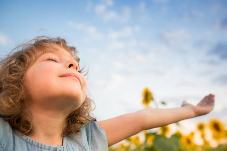 Girl with eyes closed happy in the sun