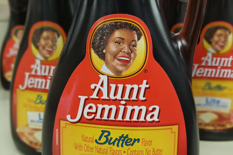 A plastic syrup bottle with 'Aunt Jemima' written across the front