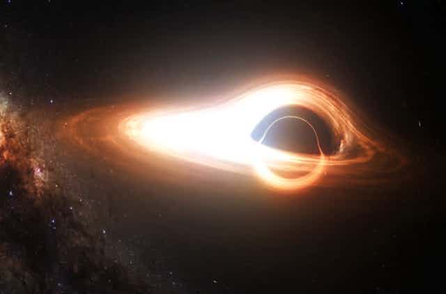 A model of a black hole with a dark centre and a donut like glowing ring around