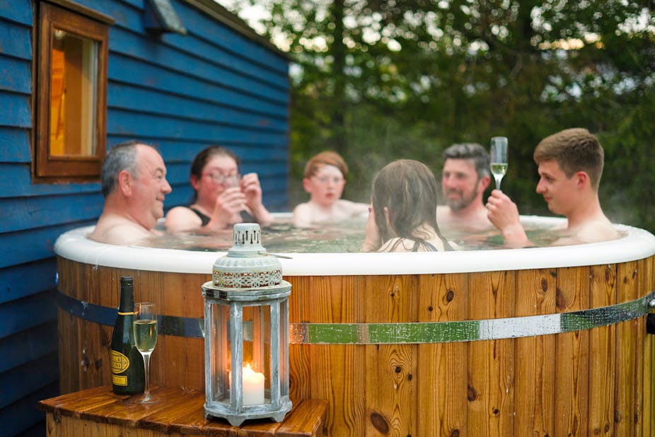 Group of people in outdoor hot tub.
