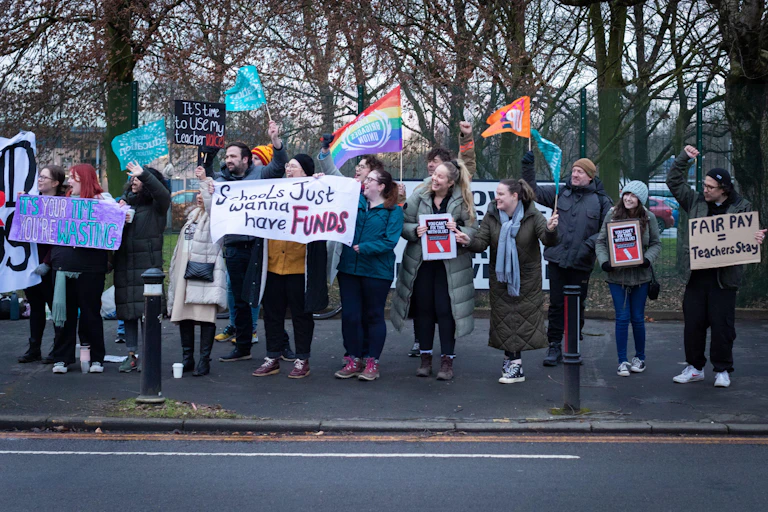 People outside holding placards