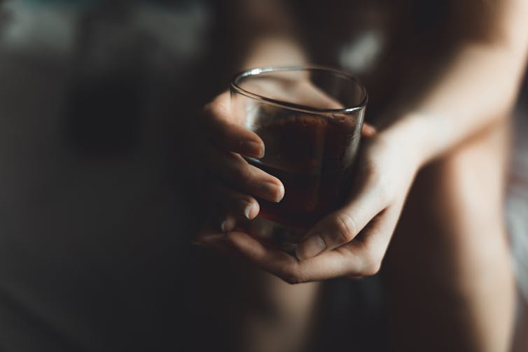 Close-up of hands holding a glass