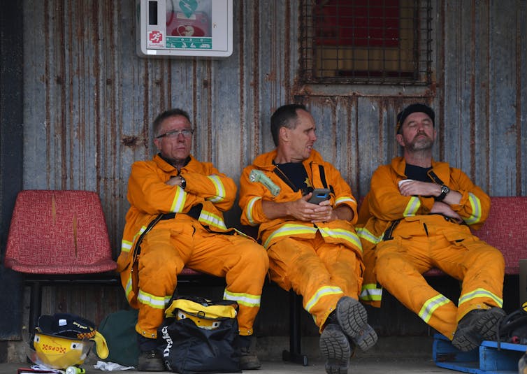 three firefighters seated
