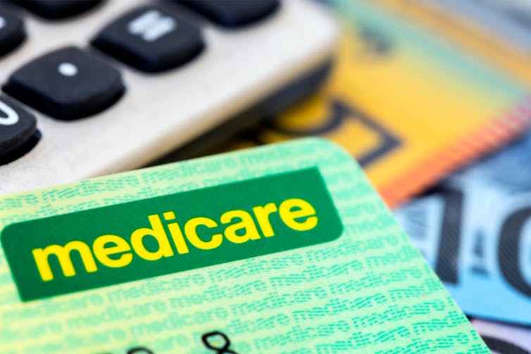 medicare card and australian currency in background