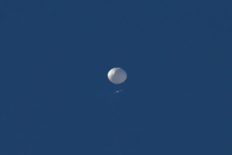 A white sphere against a clear blue sky