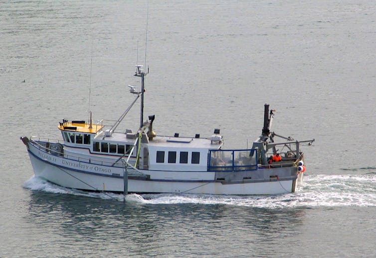 A white boat with 'Polaris II' and 'University of Otago' on the side travels across the ocean