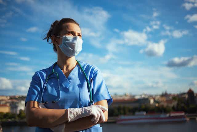 health worker with blue sky behind
