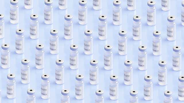 Generic influenza vaccine vials arrayed against a clear background