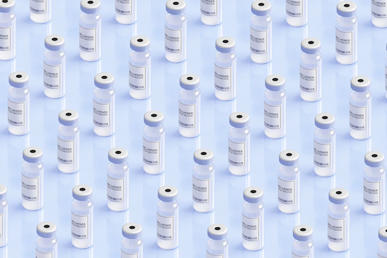 Generic influenza vaccine vials arrayed against a clear background