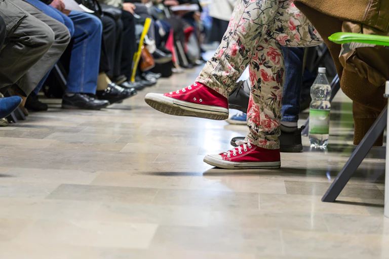Legs of people in waiting room