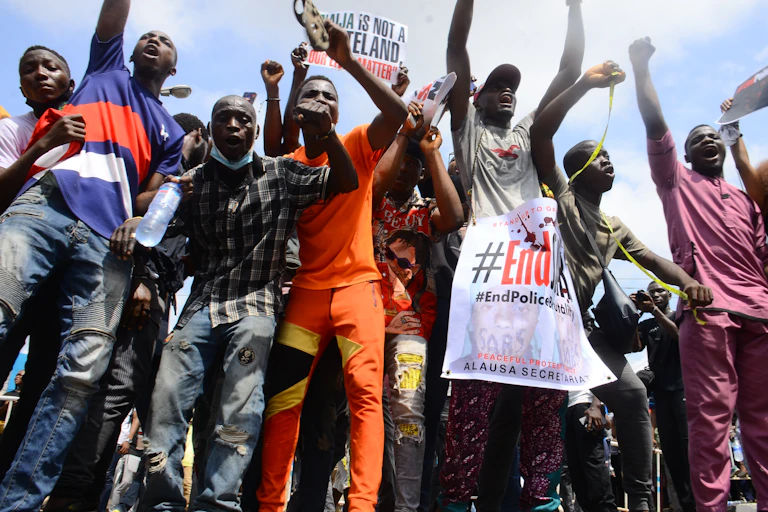 Some young men raising their hands and shouting.