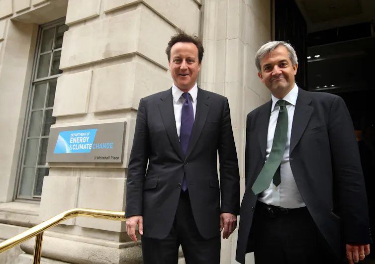 David Cameron and Chris Huhne smiling outside the DECC building.