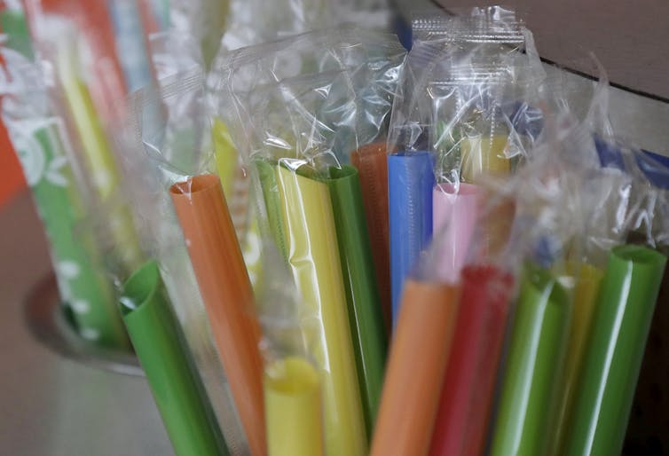 bundle of plastic straws, each wrapped in clear plastic sleeve