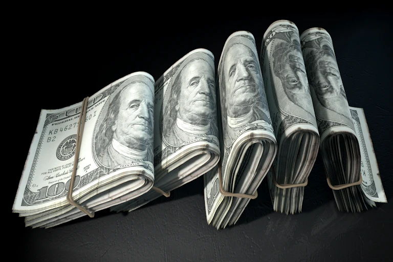 Five thick rolls of $100 each bound with rubber bands