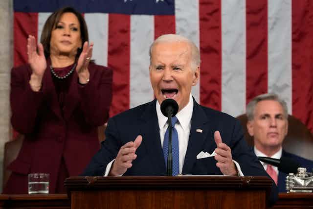 President Joe Biden delivers speech while Kamala Harris stands and claps and Kevin McCarthy sits behind him