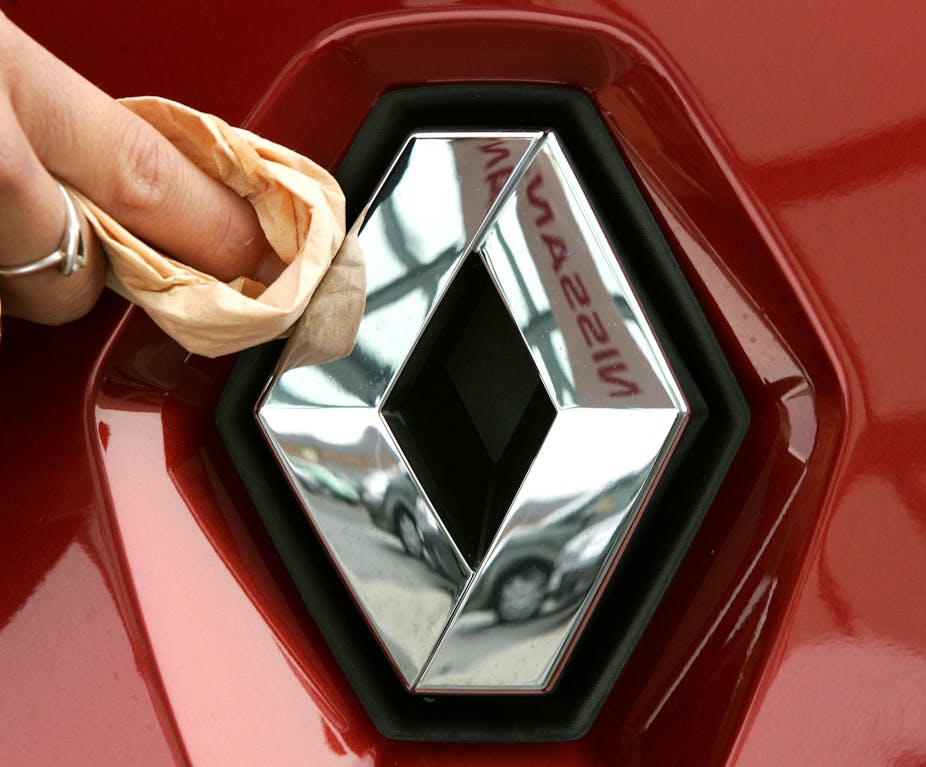 A hand polishes the logo of the French car manufacturer Renault at a car dealer in Duesseldorf, Germany, 5 January 2005. 
