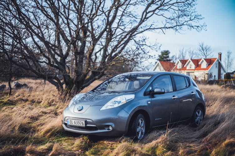 silver gray NISSAN LEAF is a compact C-segment electric car . New car on a sunny autumn day
