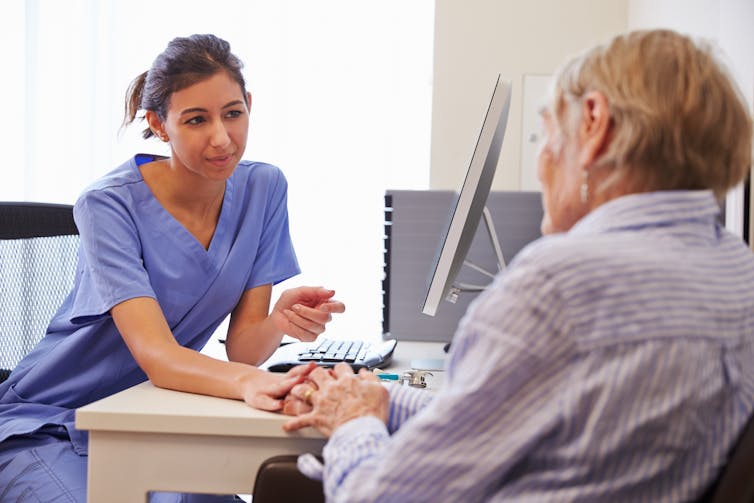 GP talks to older patient