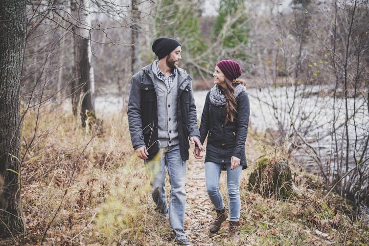 A couple walking in a park.