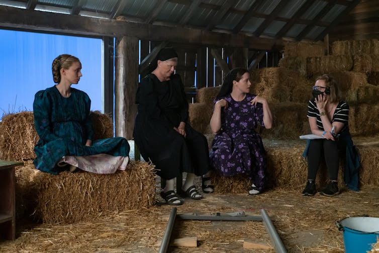A director talks to the cast.