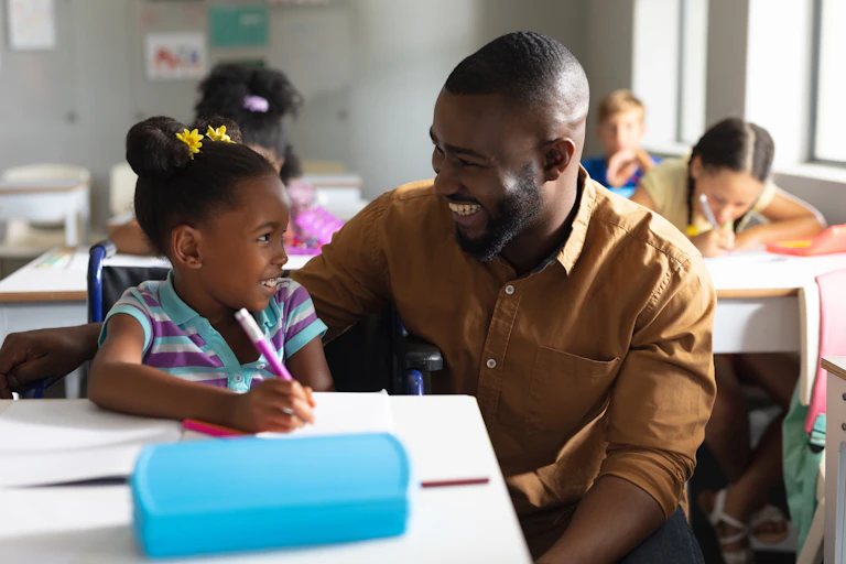 Teacher and pupil smiling at each other