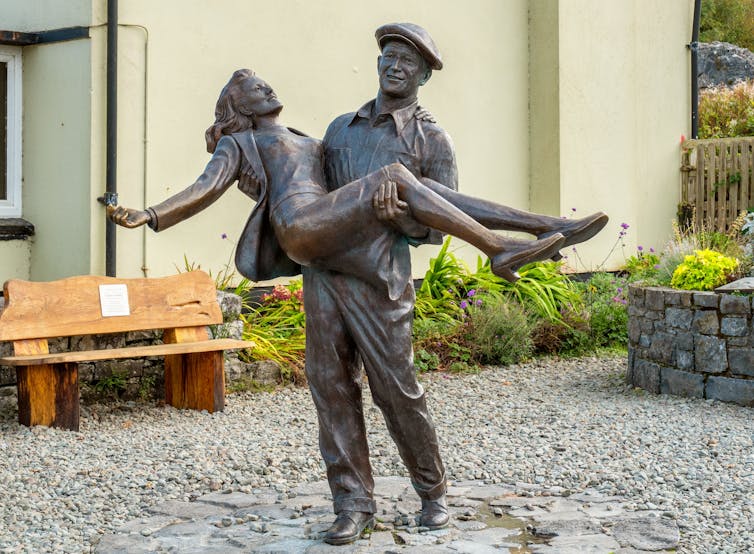 Bronze statue of John Wayne lifting Maureen O'Hara, depicting the Irish film The Quiet Man. Cong, west of Ireland.
