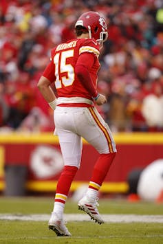 A football player limping.