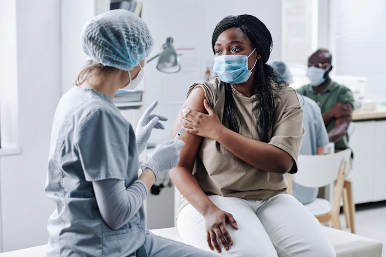 A woman receiving a vaccine.