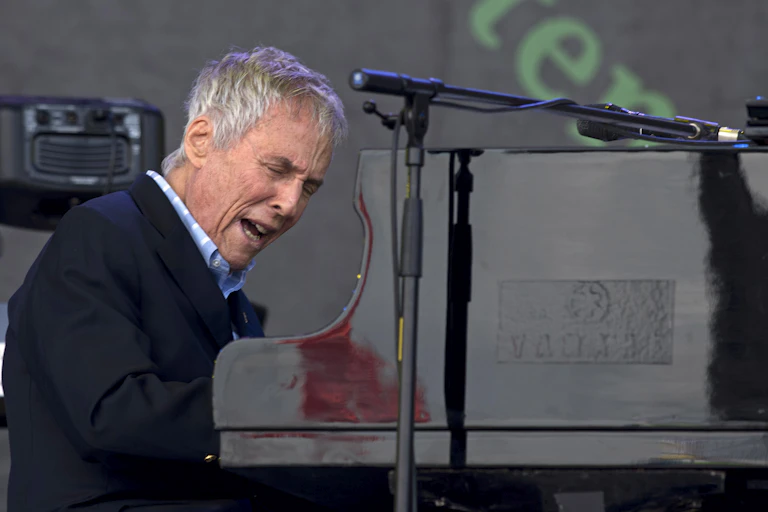 Mans sings at piano.